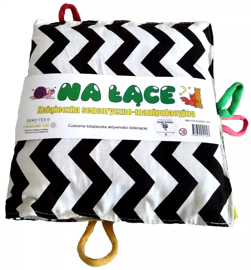 Książeczka sensoryczno-manipulacyjna. Na łące - Zabawki